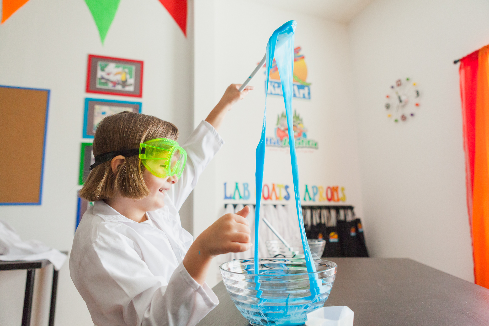 Student making slime in lab coat